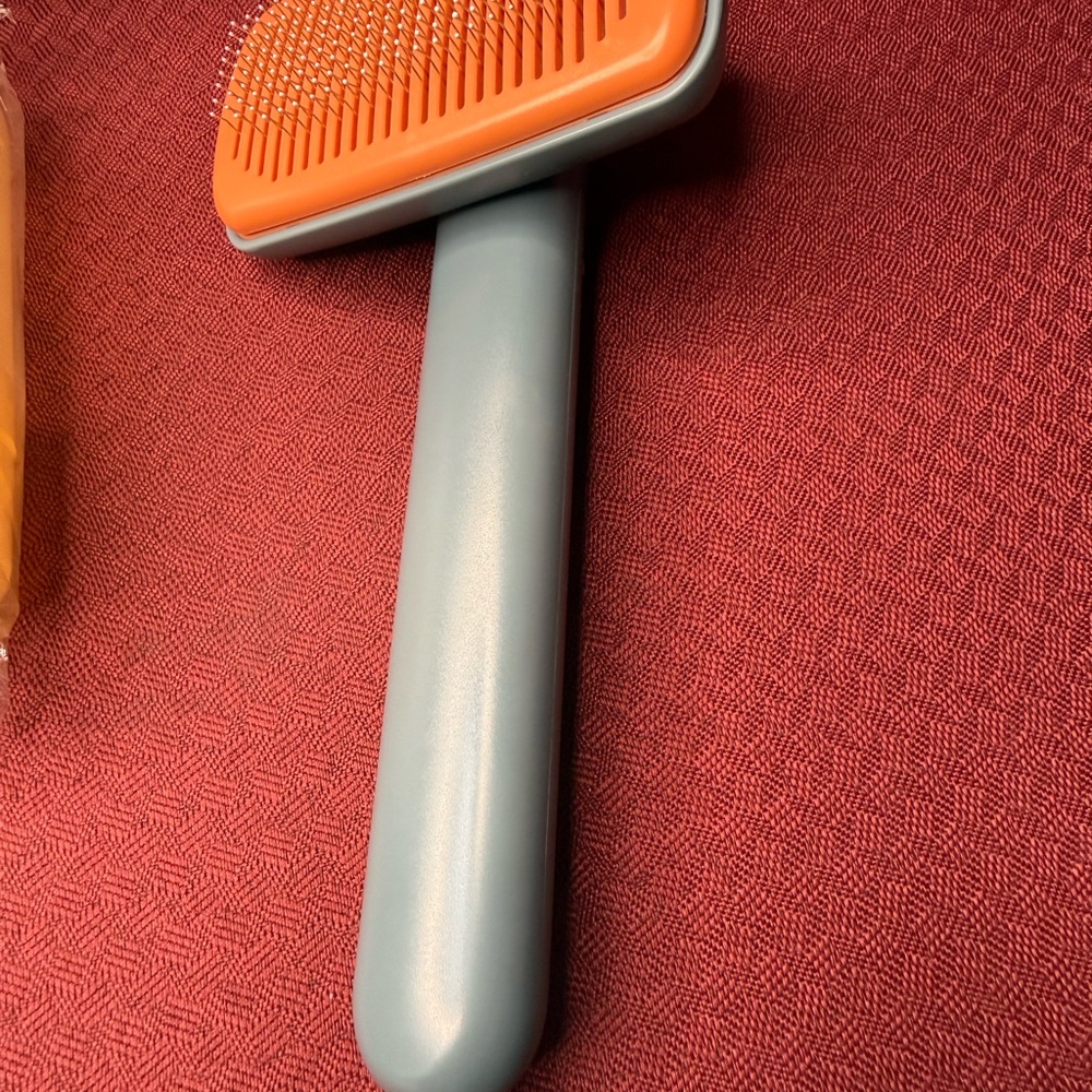 Orange and Gray Grooming Brush
